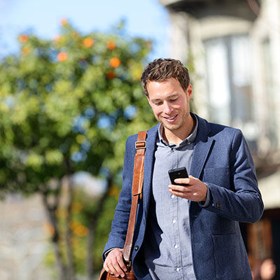 Man shopping on cell phone on the go.